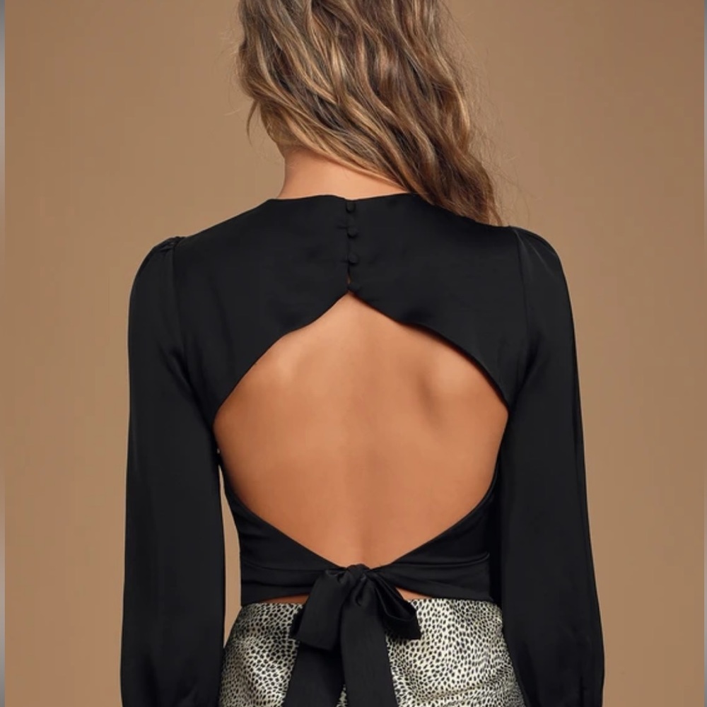 Black blouse, cut out back with tie in back. Silk material-never worn